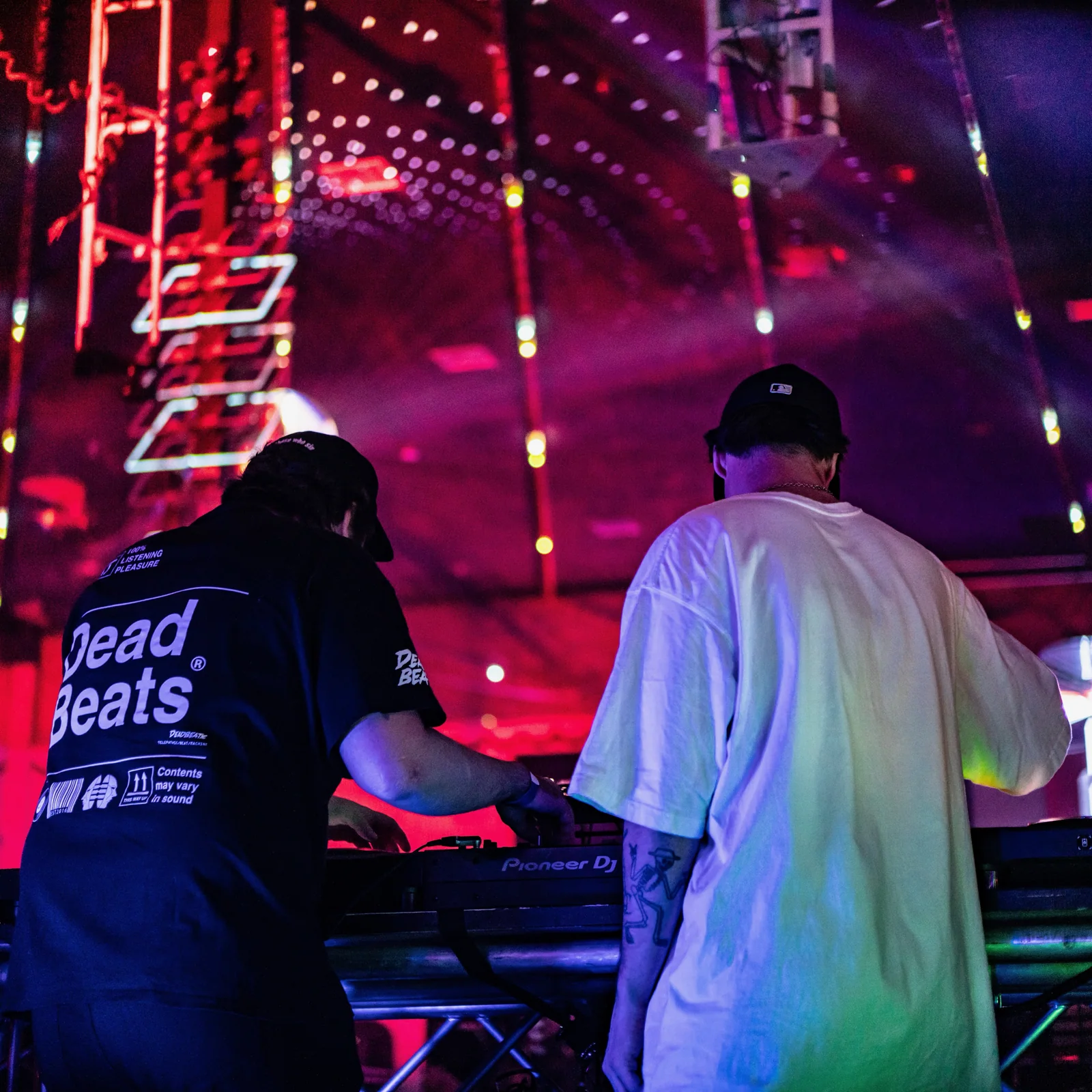 Due Dilla Gents performing together under red and violet lights at Elektricity